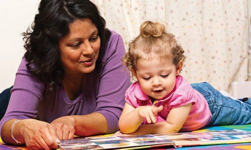 Women reading to a small child