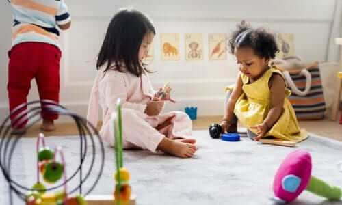 Little kids playing toys in the playroom