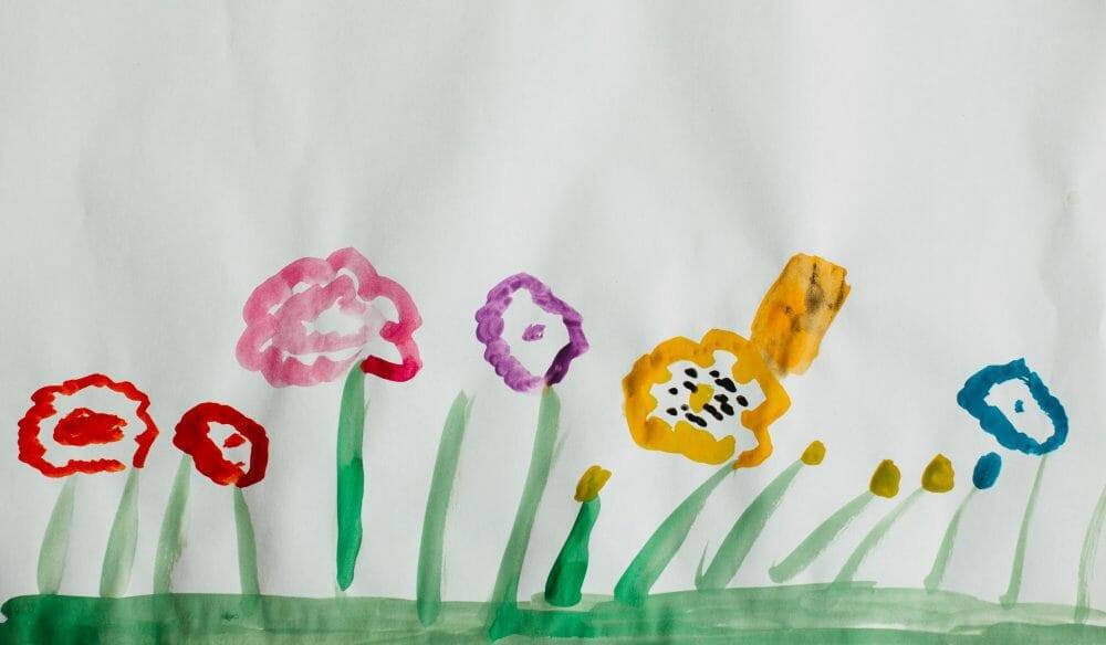 Kids painting flowers with water colors.