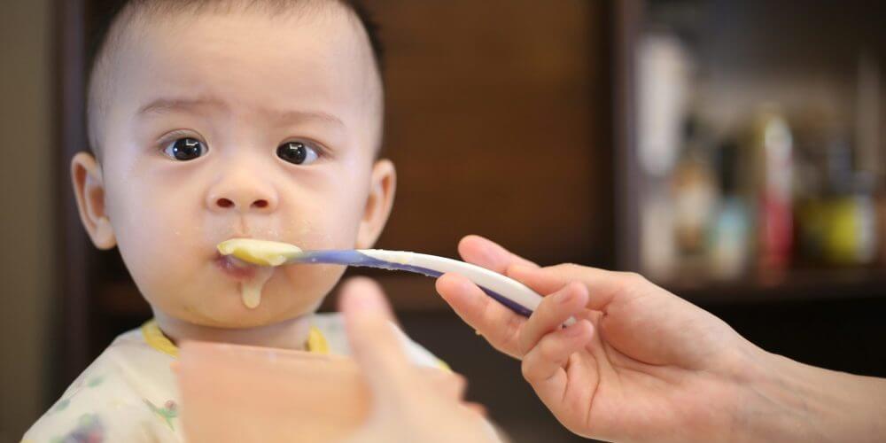Mom feeding baby with a spoon