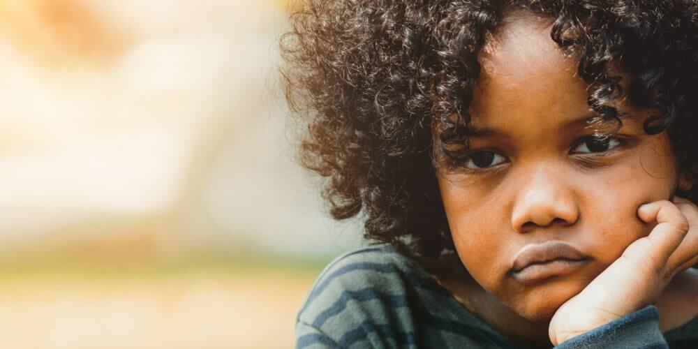 Sad Black child in the park.