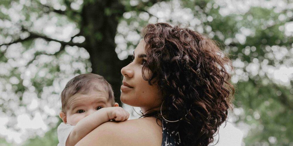mother-earth-stockpack-unsplash Mother holding baby outdoors